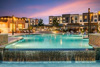 Resort-style swimming pool with sunning ledge, plunge pools, cabanas, and fire pit